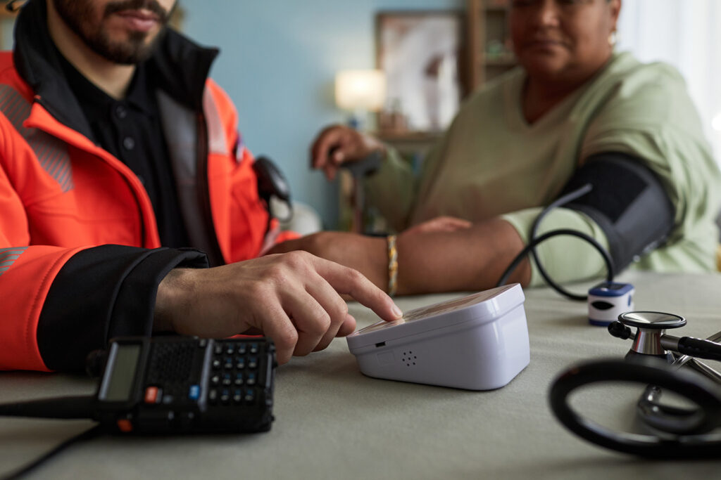 Male paramedic measuring blood pressure of middle 2026 01 11 10 30 29 utc