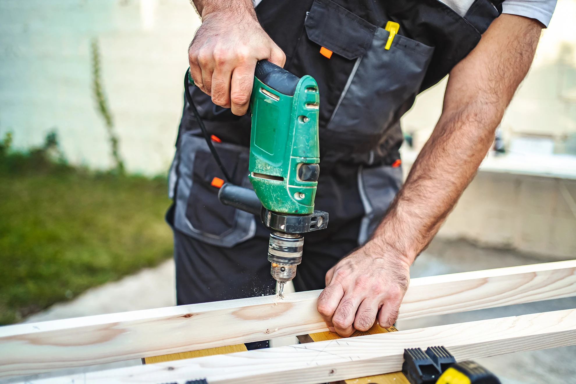 Carpenter drilling wood outdoors with power tool 2026 03 16 05 13 41 utc