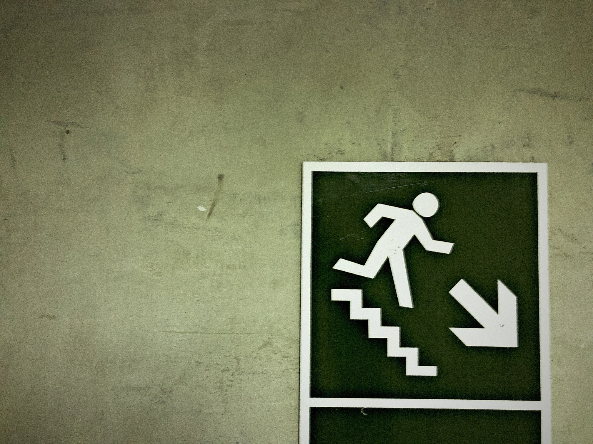 Emergency exit sign on a textured wall 2026 03 18 04 35 14 utc